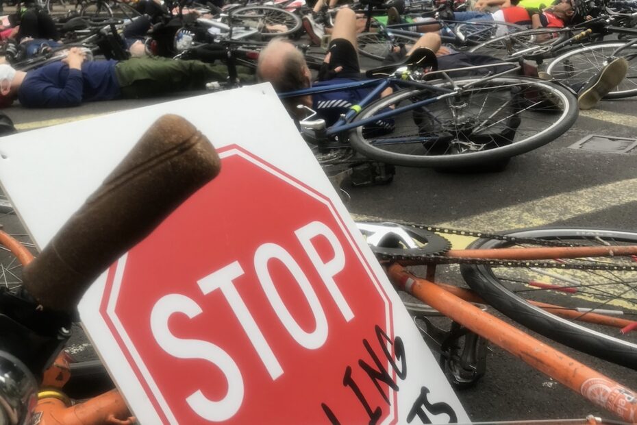 cyclists lying down in protest blocking junction